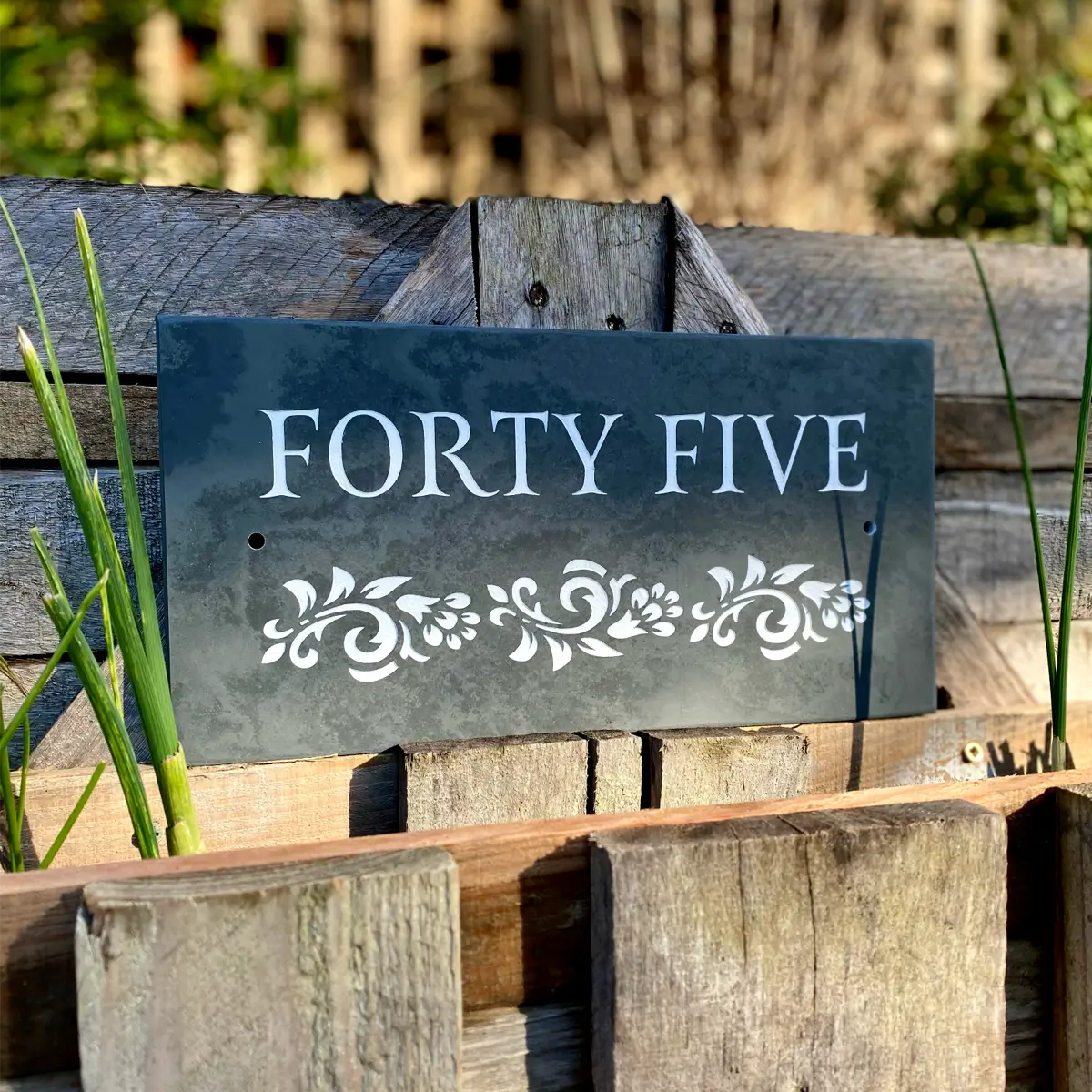 rectangle slate house sign with leaf design in white and green engraving