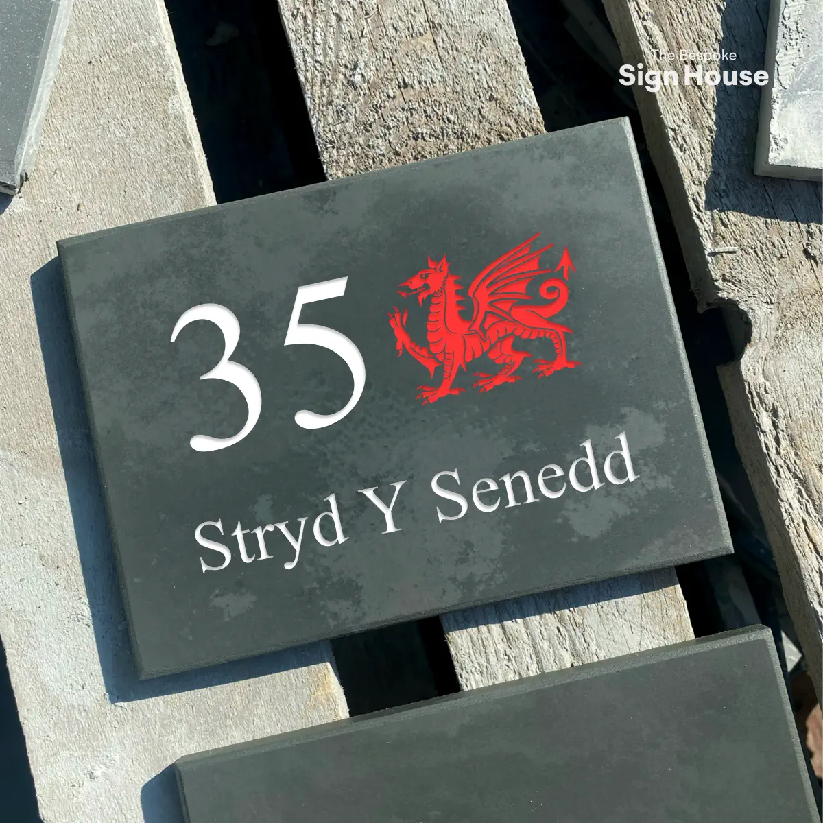 slate house sign with house number, street name and red welsh dragon